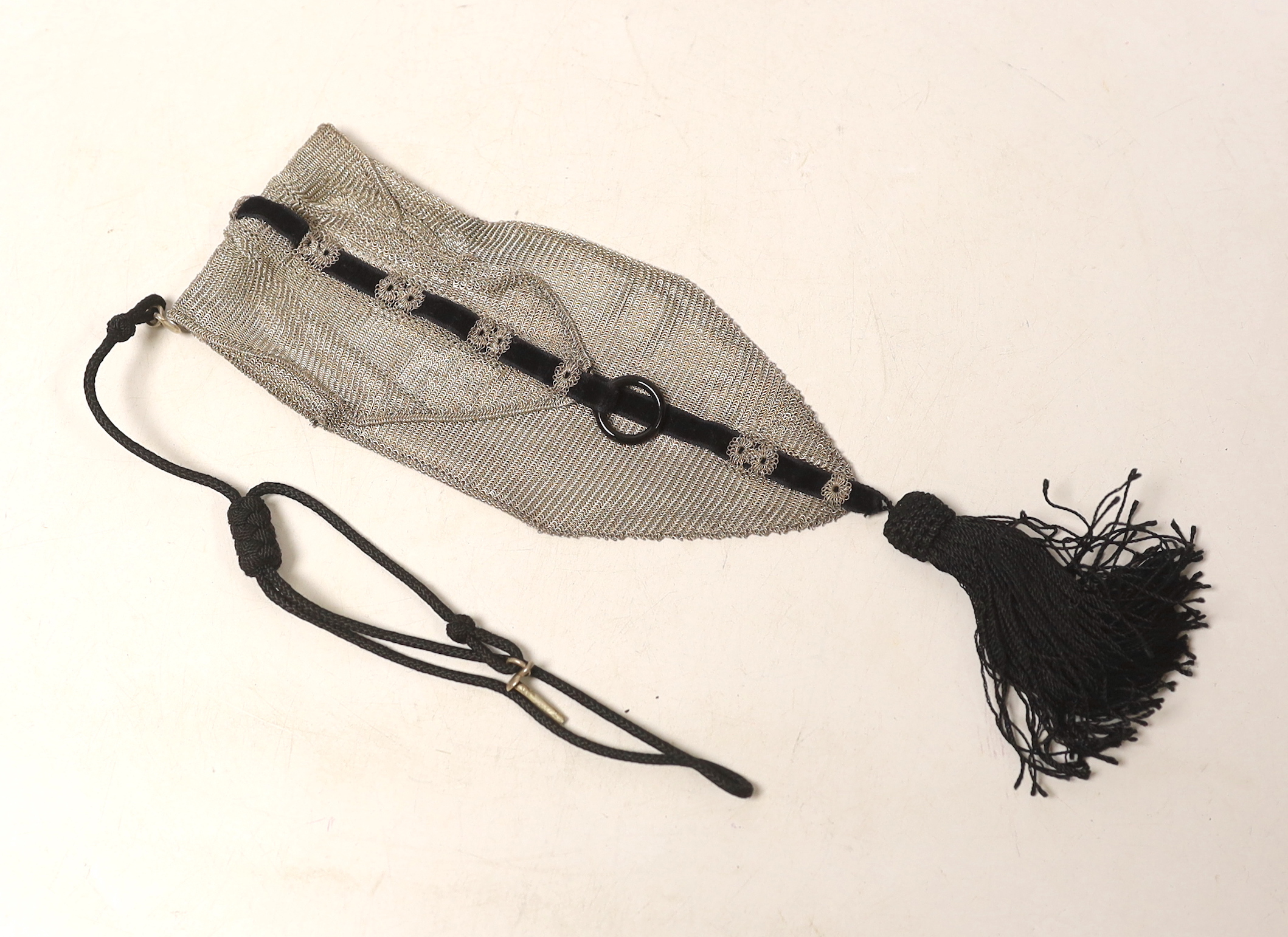 A 1920's silver mesh and black sash with tassel mounted evening bag, with black suspension cord, import marks for Cohen & Charles, no date letter, overall 42cm